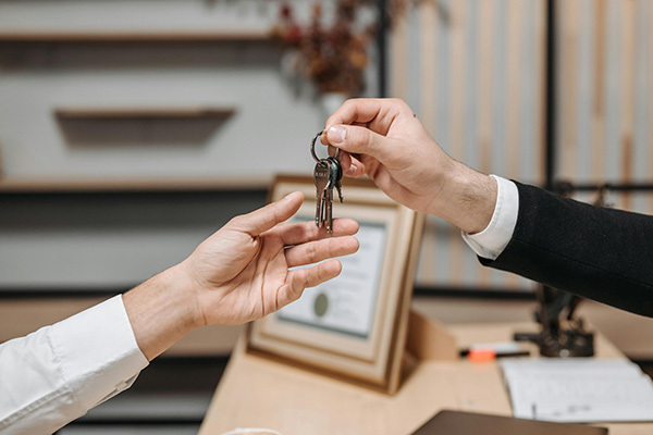 Photo - Handing the keys to a property manager Photo - Handing the keys to a property manager
